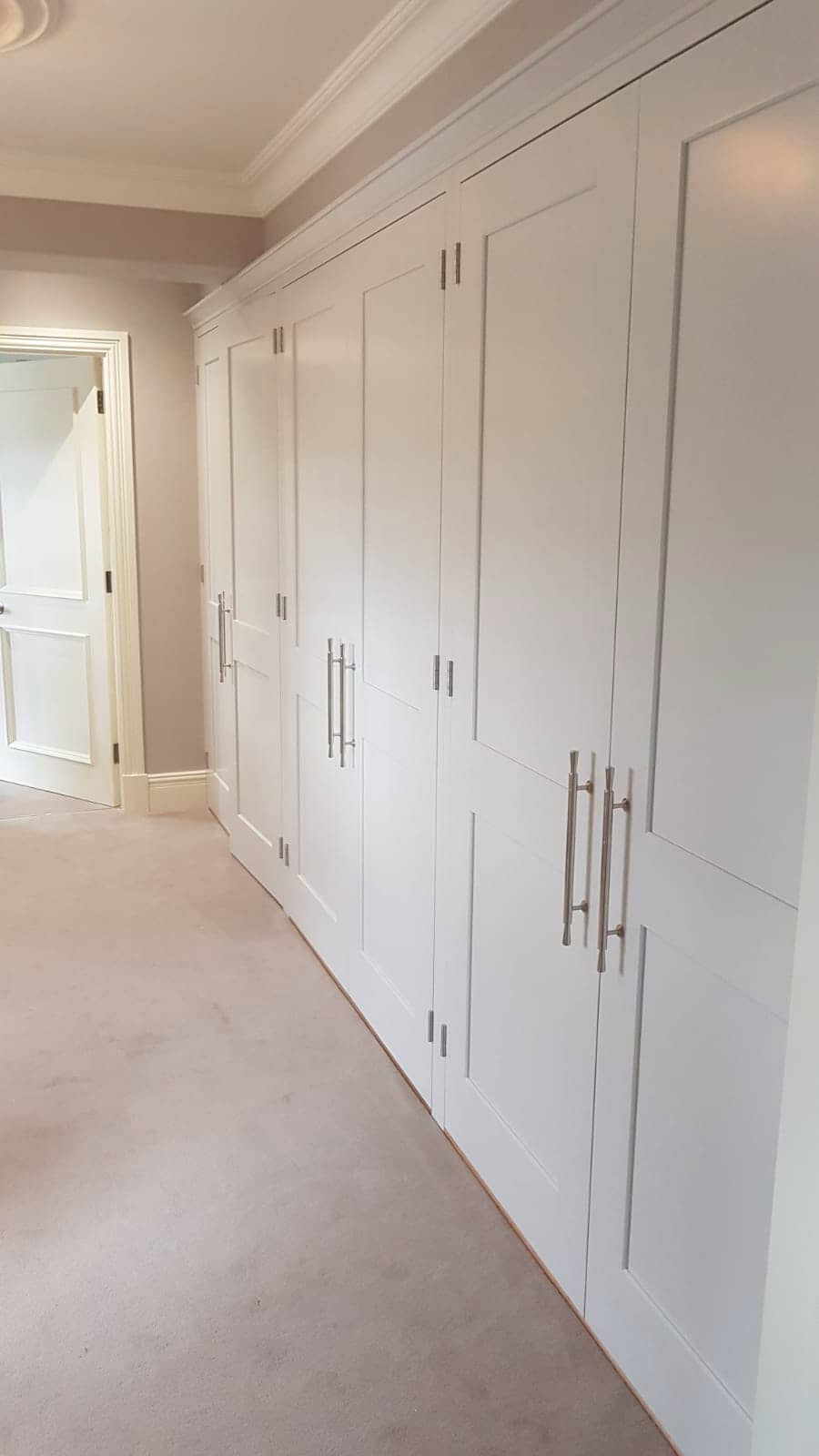 Fitted bedroom with floor-to-ceiling wardrobes