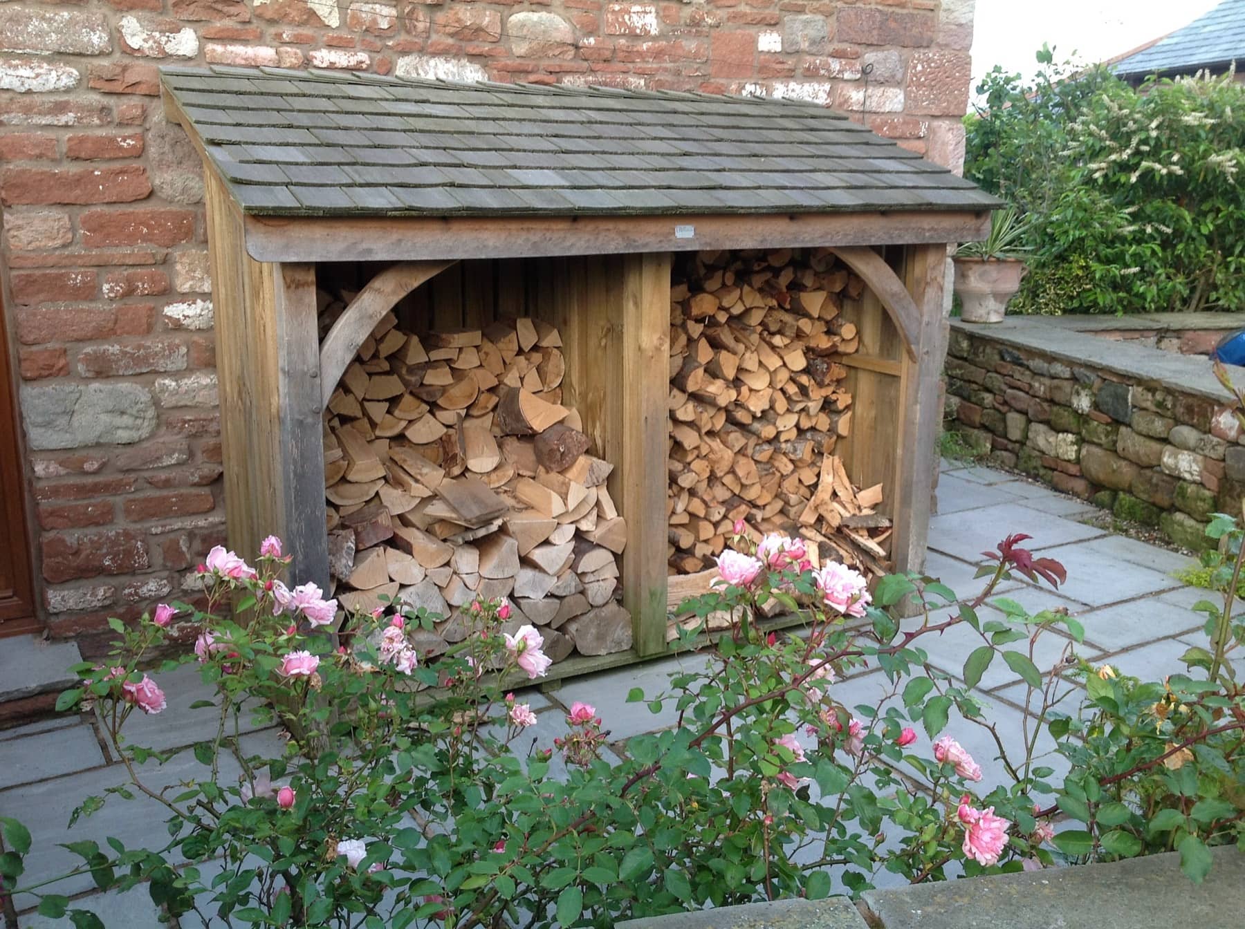 Oak framed log store with cedar shingle roof